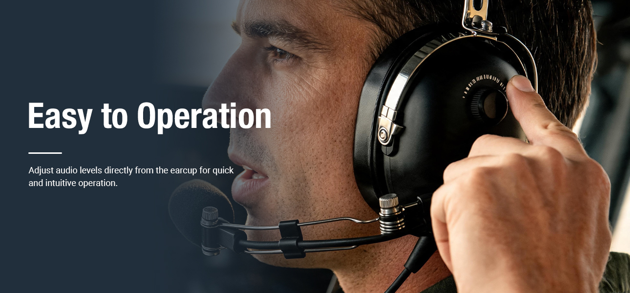 Helicopter pilot using Pilot Headphones with earcup volume control for quick audio adjustment